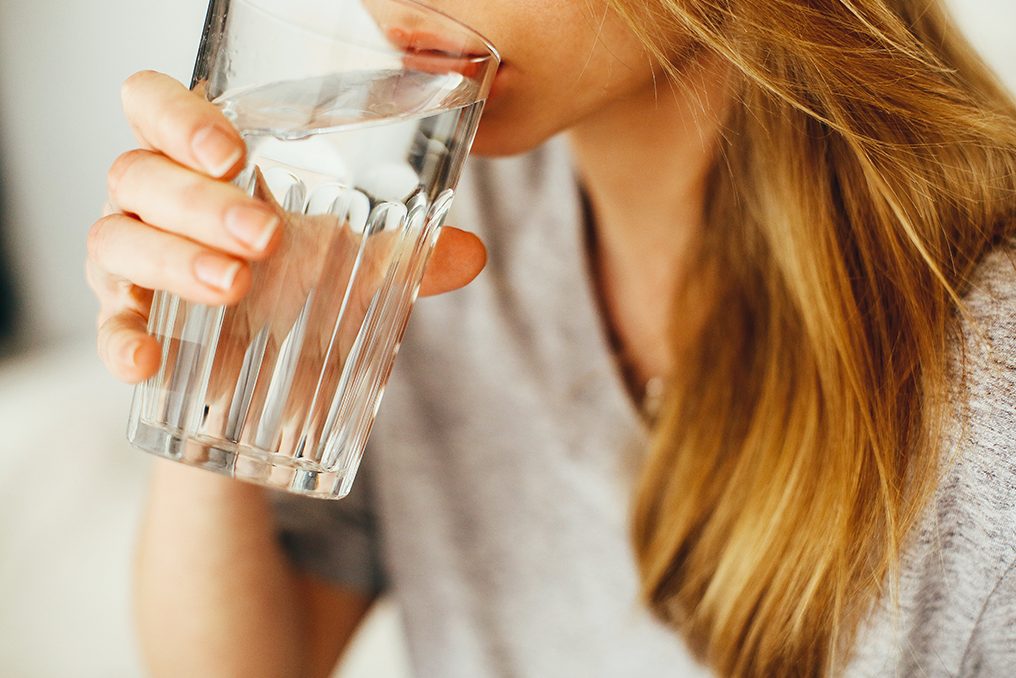 4 Reasons Why You Should Drink More Water, image of a woman drinking water