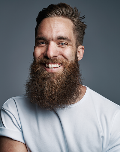 Dental Sealants, image of a man with a beard smiling.