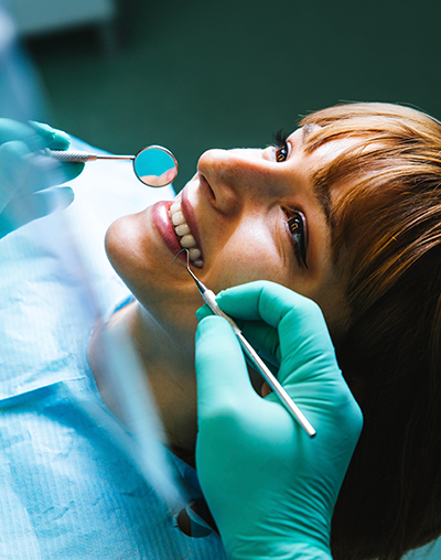 Oral Surgery, image of a woman at the dentist preparing for oral surgery