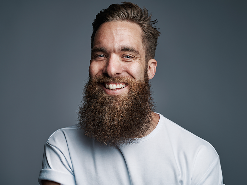dental services, Dental Sealants, image of a man with a beard smiling.