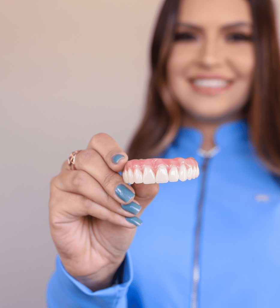 Denture-dentist-mira-mesa, How to Take Care of Dentures, image of a woman holding dentures